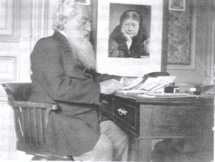 Col. Olcott at his desk with framed photo of HPB.